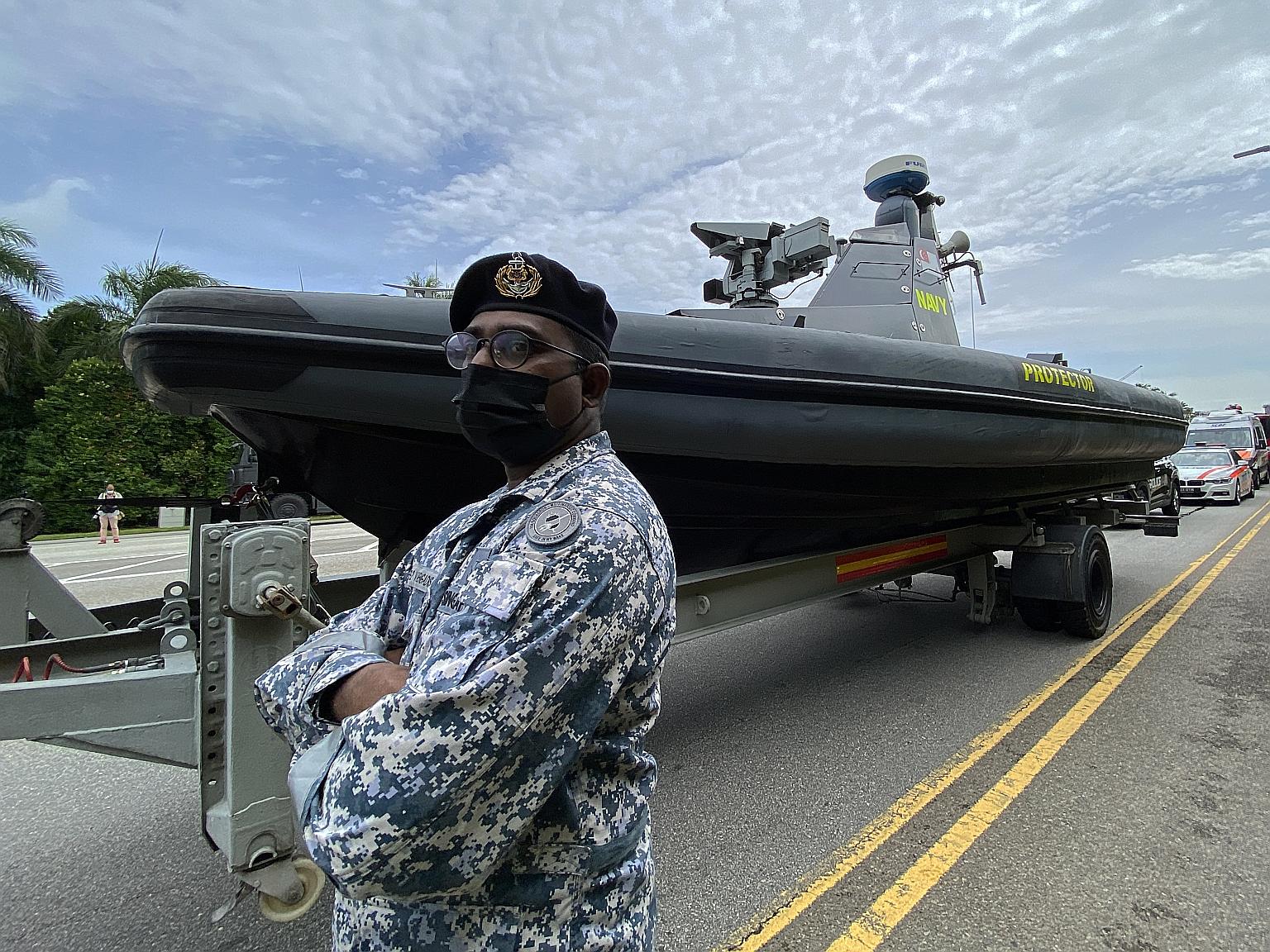 Military Expert 2 Vaengadis Waran standing in front of the Republic of Singapore Navy's Protector Unmanned Surface Vessel, which will be part of the mobile column in today's parade.