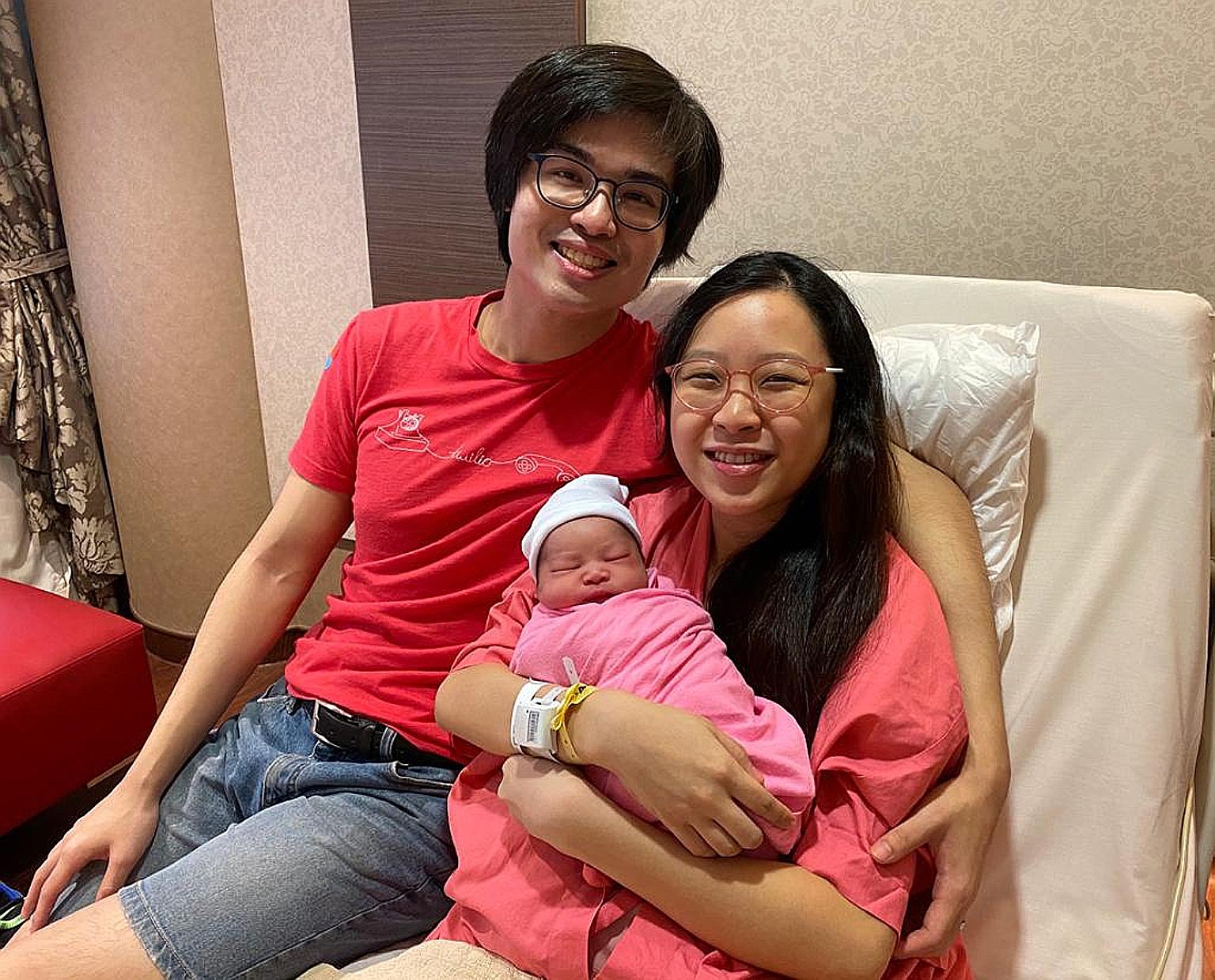 Mr Jonathan Tan and his wife Natalie with their daughter Matilda, who was born at the stroke of midnight at KK Women's and Children's Hospital, making her this year's first National Day baby.