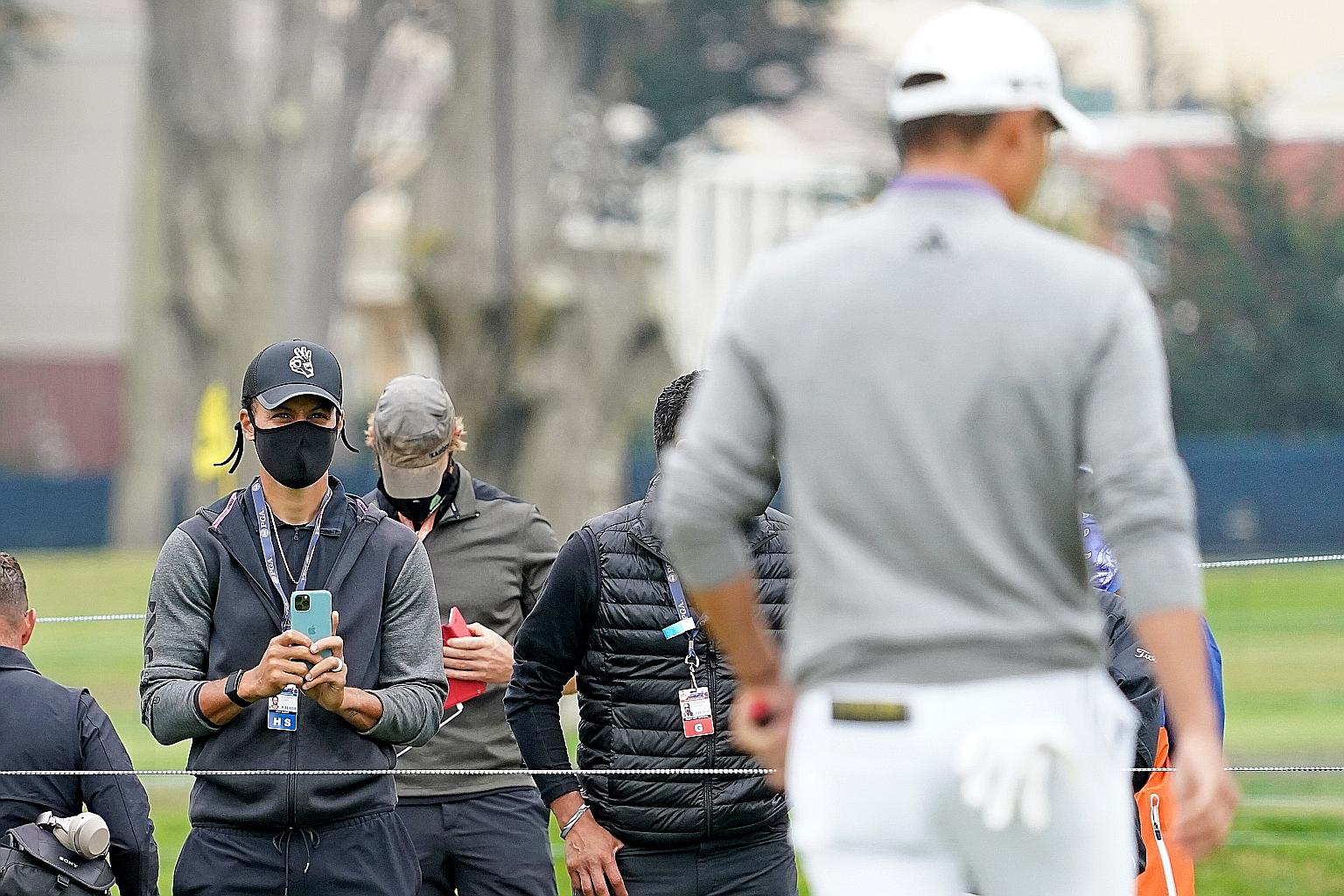 Warriors guard Stephen Curry getting a shot of eventual winner Collin Morikawa from the ropes in Sunday's PGA Championship final round.