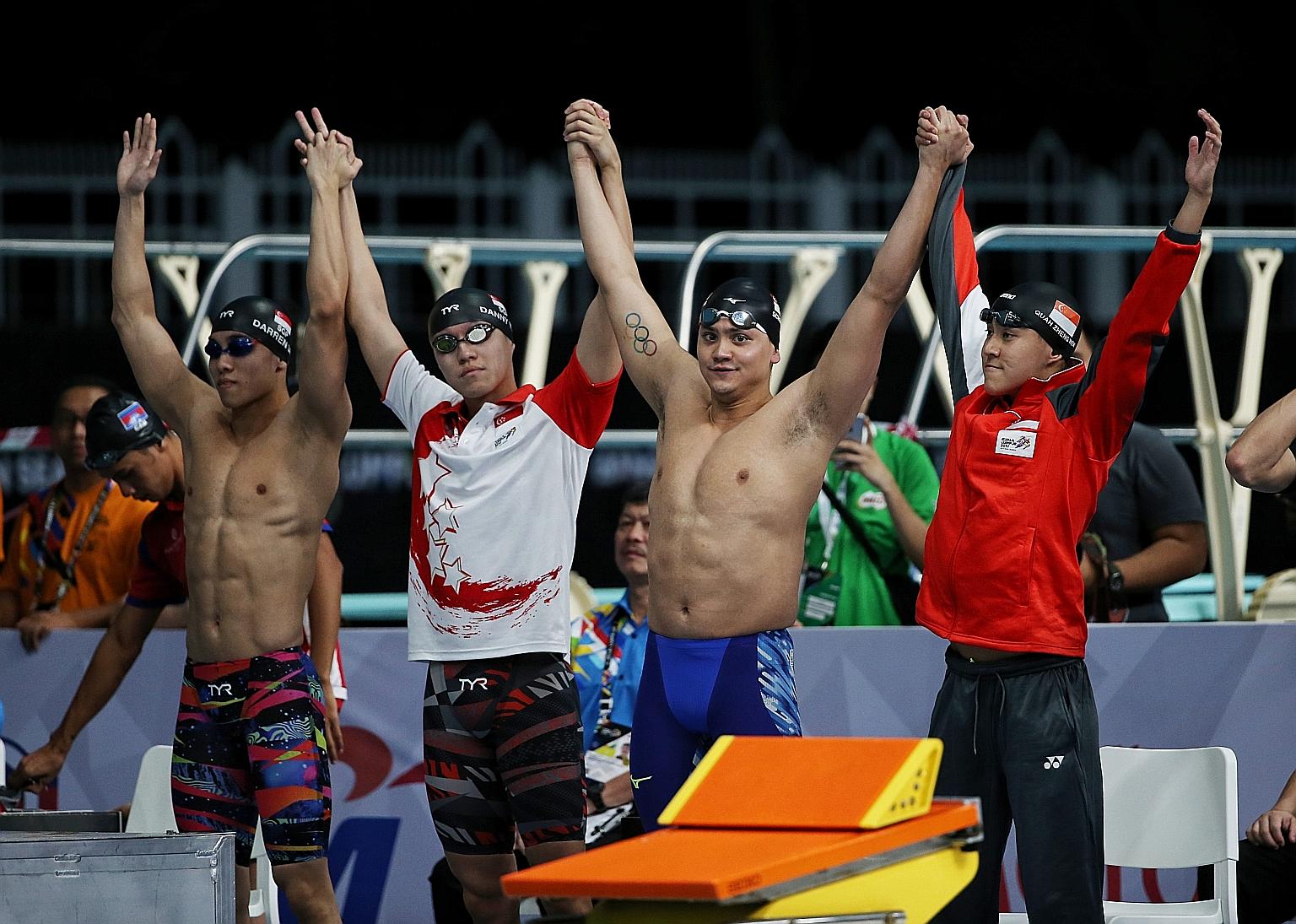 Olympic champion Joseph Schooling (second from right) and Quah Zheng Wen (extreme right) can continue to train "unhindered" for the Tokyo Games after Mindef granted the pair extensions to their national service deferments.