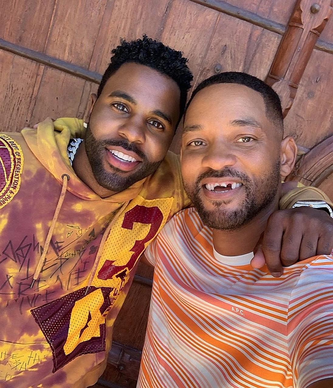 Will Smith (right) posted a video of Jason Derulo (left) appearing to knock out his teeth on social media on Sunday.