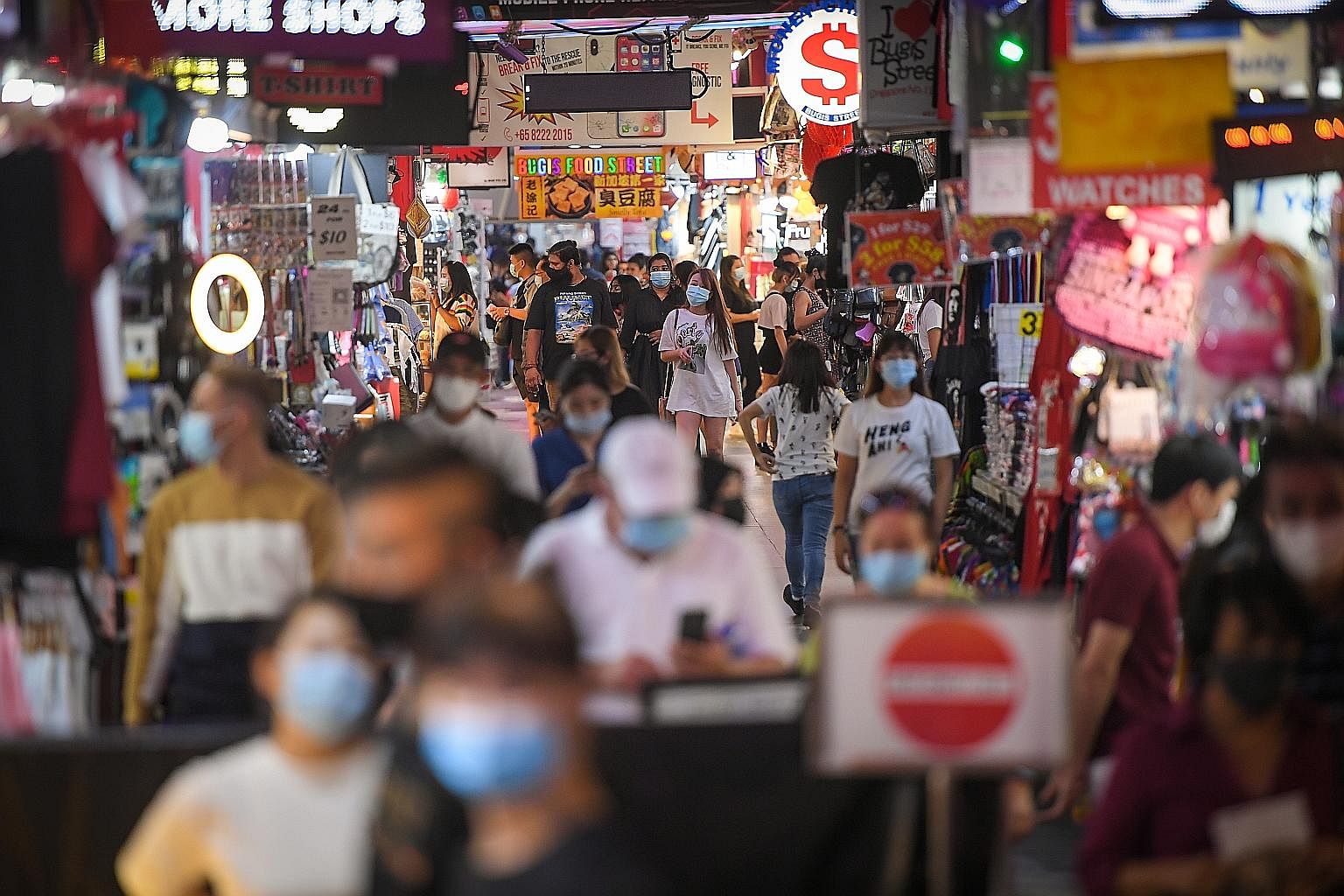 The bustle in Bugis Street on Monday, with the masks on people's faces the only giveaway that Singapore is still battling a pandemic. The currently low infection numbers here and the greater freedom to move around are a reward for everyone working to