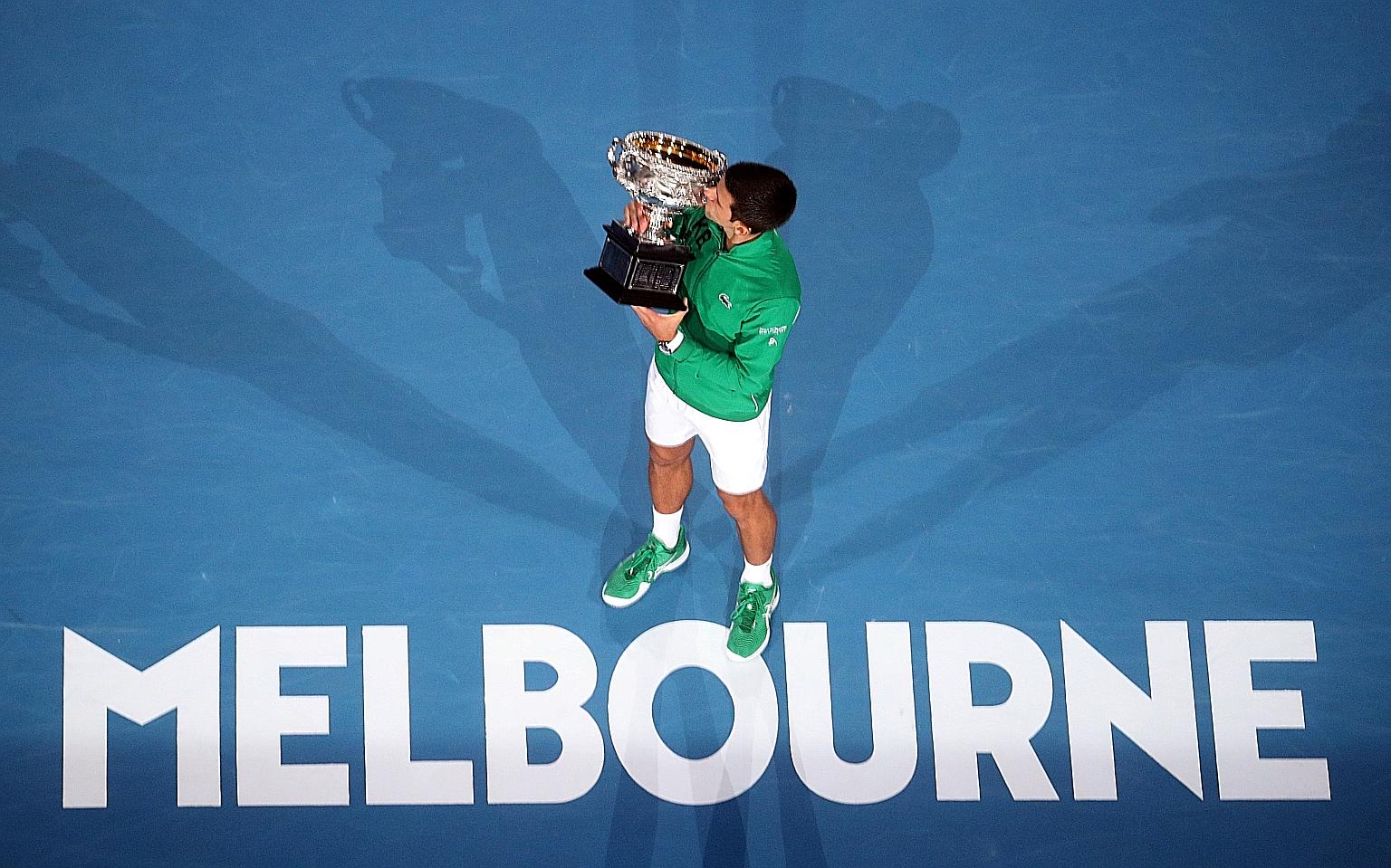 Serbia's Novak Djokovic kissing the trophy after winning the Australian Open final against Dominic Thiem of Austria in February for a 17th Grand Slam title.