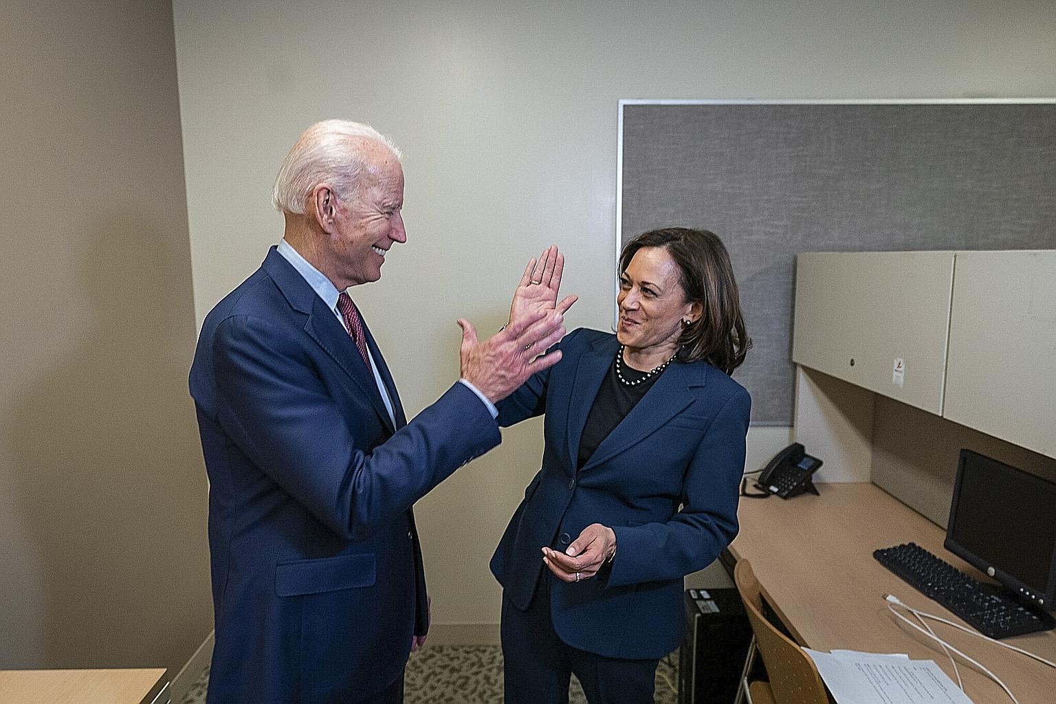 US Democratic presidential candidate Joe Biden and Senator Kamala Harris high-fiving in an undated photo. They were set to make their first campaign appearance together yesterday in Wilmington, Delaware, as the race for the White House enters a more