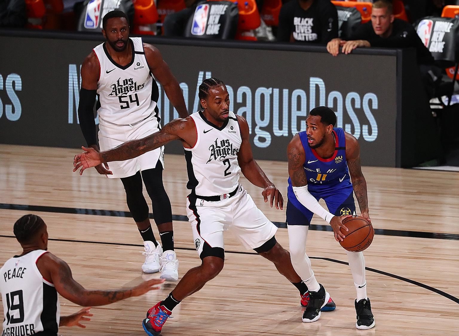 Denver Nuggets guard Monte Morris (extreme right) comes up against LA Clippers forward Kawhi Leonard at the AdventHealth Arena on Wednesday. The Clippers secured the second seed in the Western Conference with their 124-111 win over the Nuggets.