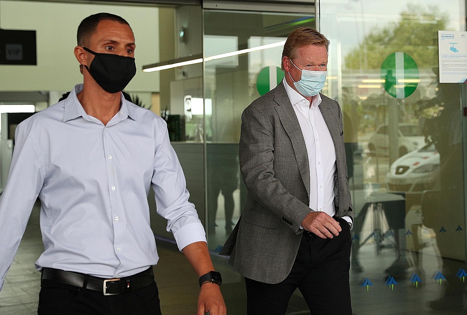 Ronald Koeman (right) seen arriving in Barcelona on Tuesday, will decide on the players to let go together with technical secretary Ramon Planes, revealed club president Josep Maria Bartomeu.