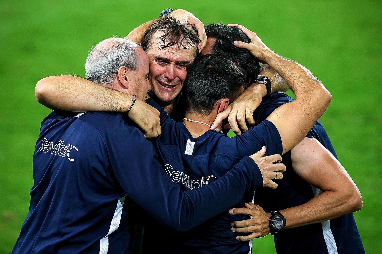 Sevilla's Julen Lopetegui in tears as he embraces his coaching staff after the team's victory in the final. The Europa League is the Spaniard's first piece of silverware as a coach.