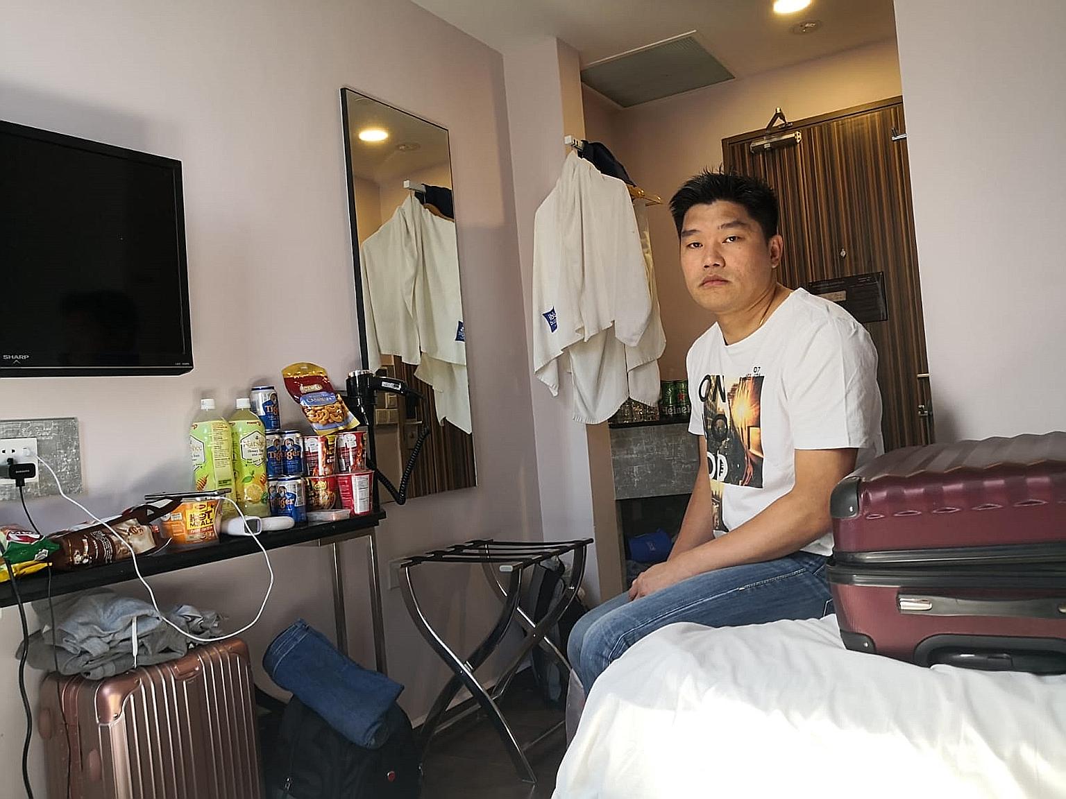 Mr Eddie Chow, seen below in a video call with his family, said his wife "is being left alone to take care of our eight-month-old son and five-year-old daughter". PHOTOS: GAIN CITY