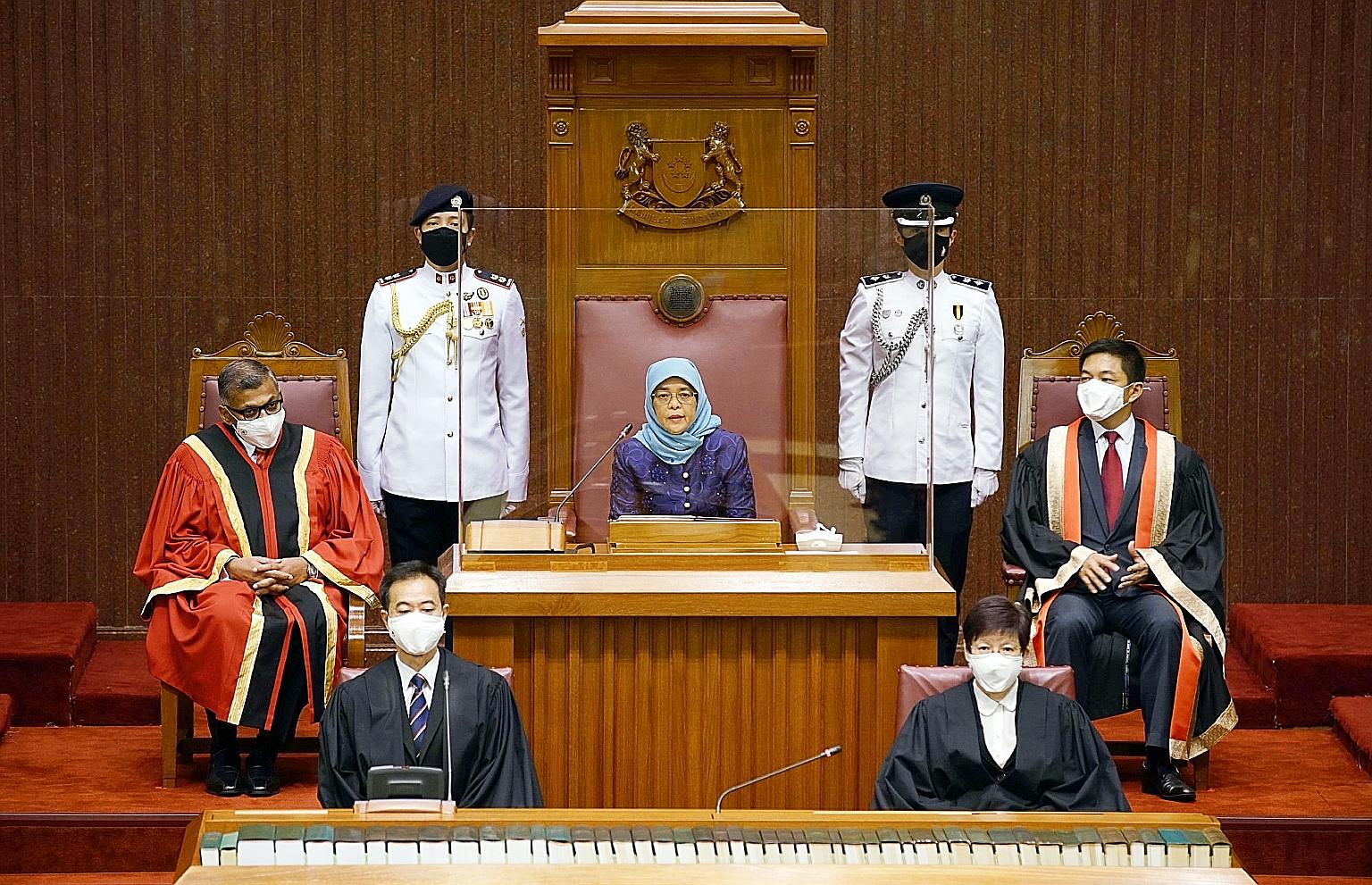 President Halimah Yacob at the opening of the 14th Parliament yesterday, flanked by Chief Justice Sundaresh Menon (far left) and Speaker of Parliament Tan Chuan-Jin. For the first time, the event took place at two locations - Parliament House and the