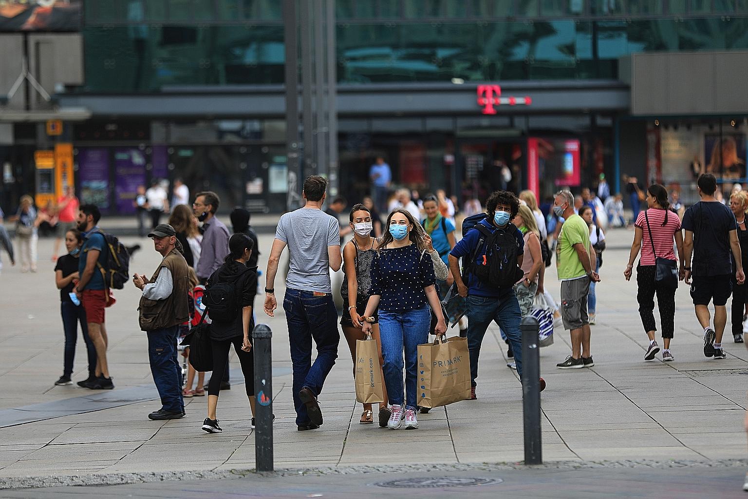 Shoppers at Berlin's Alexanderplatz public square on Monday. Consumer spending in Germany shrank by 10.9 per cent on the quarter, capital investments by 19.6 per cent and exports by 20.3 per cent, seasonally adjusted data showed. PHOTO: BLOOMBERG