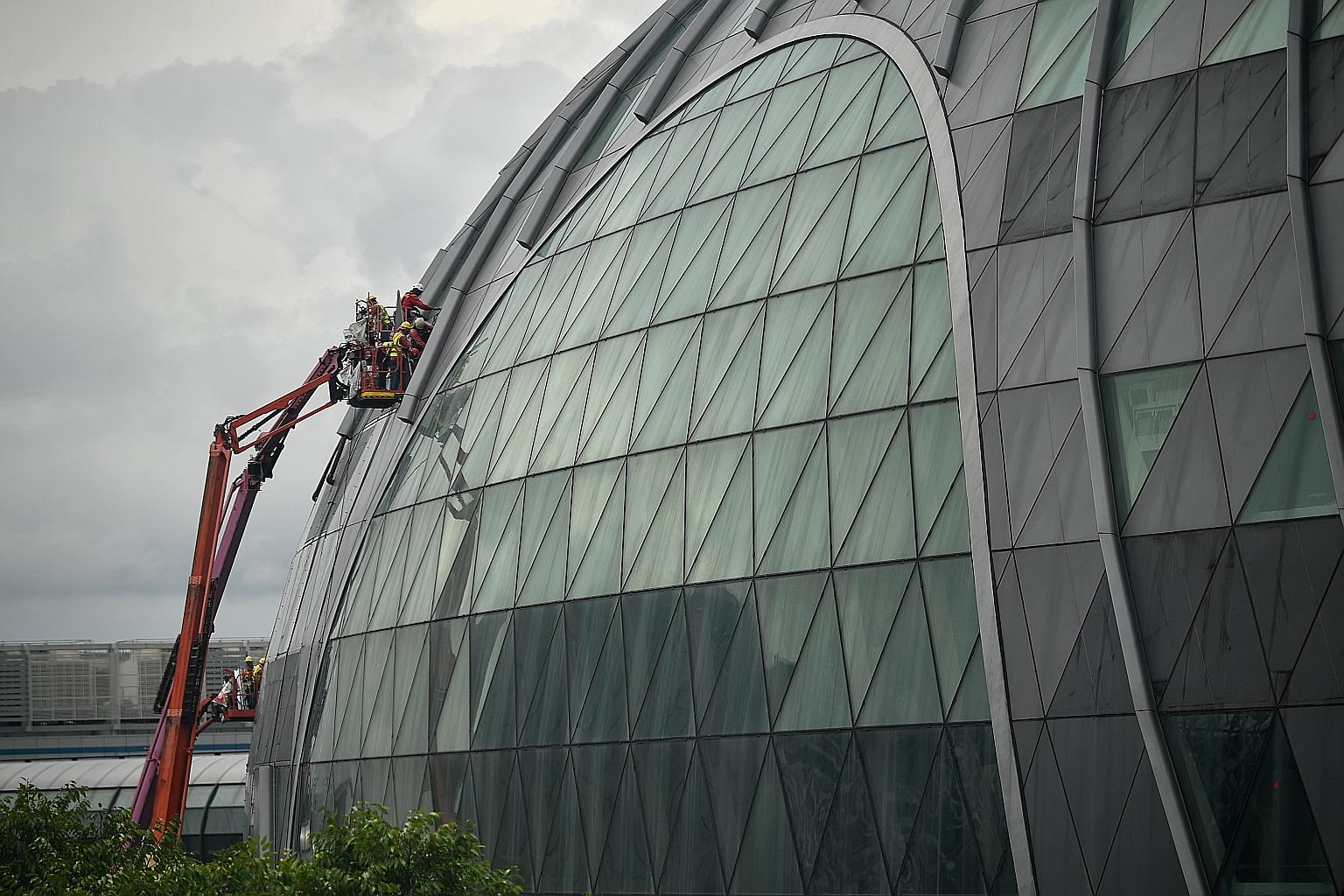 Maintenance work being carried out on the exterior of Jewel Changi Airport yesterday. Travel restrictions were recently eased for passengers from Indonesia, Malaysia and Thailand, who will now be able to transit at Changi Airport via Singapore Airlin