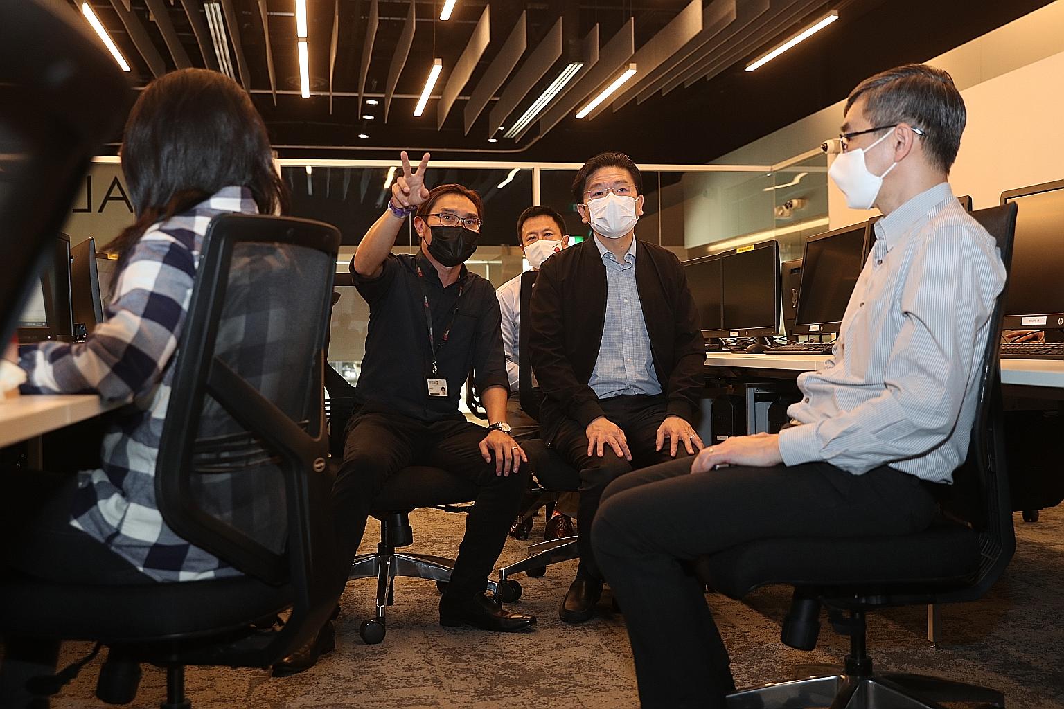 Education Minister Lawrence Wong (second from right) being briefed by Singapore Polytechnic senior lecturer Chris Ho while observing a class for one of the new courses yesterday. Also present were SkillsFuture Singapore chief executive Ong Tze Ch'in
