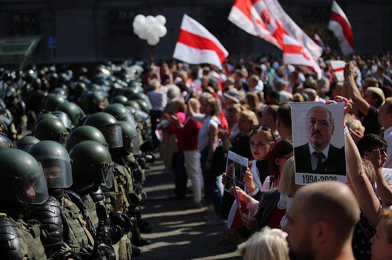 Law enforcement officers blocking a street as opposition supporters protested in Minsk yesterday against the presidential election results. Belarusian President Alexander Lukashenko is struggling to contain weeks of protests and strikes after winning