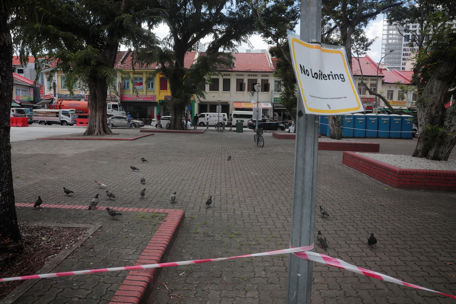 A square in Little India where foreign workers used to gather remains cordoned off. Most migrant workers at dormitories remain confined to their quarters, which is bad news for businesses in the area that rely on them. ST PHOTO: JASON QUAH