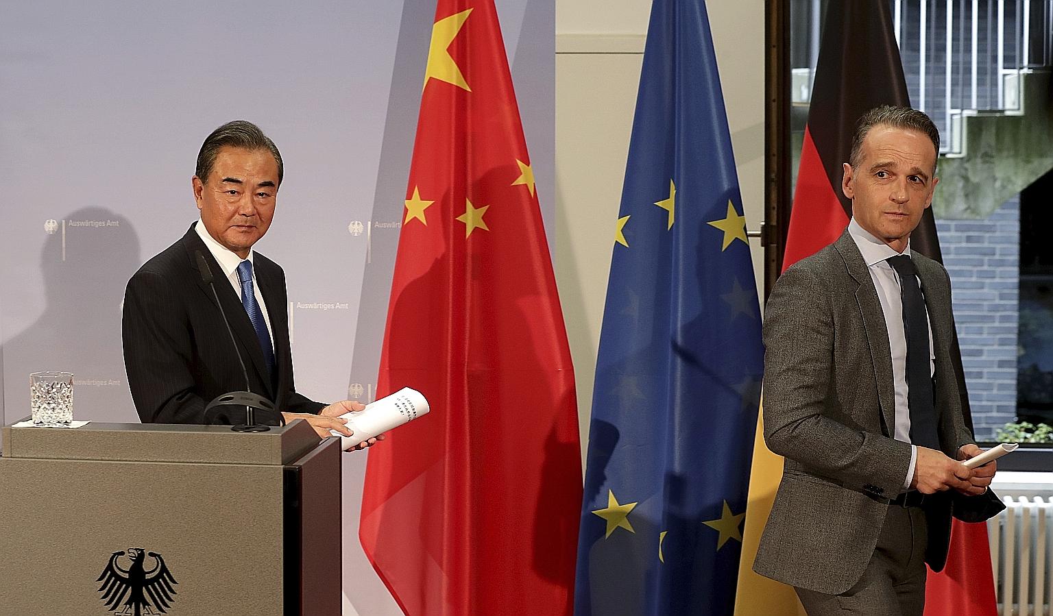 Chinese Foreign Minister Wang Yi and German Foreign Minister Heiko Maas at a media briefing in Berlin on Tuesday, where Mr Maas emphasised that Europe would not be intimidated.