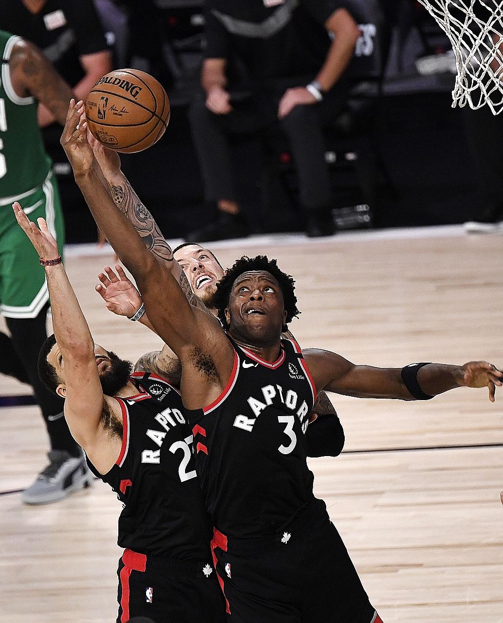 Toronto's O.G. Anunoby fighting for possession against Boston on Thursday in Florida. His buzzer beater meant the Raptors edged out the Celtics 104-103 and cut the deficit to 2-1 in their Eastern Conference semi-final series. PHOTO: AGENCE FRANCE-PRE