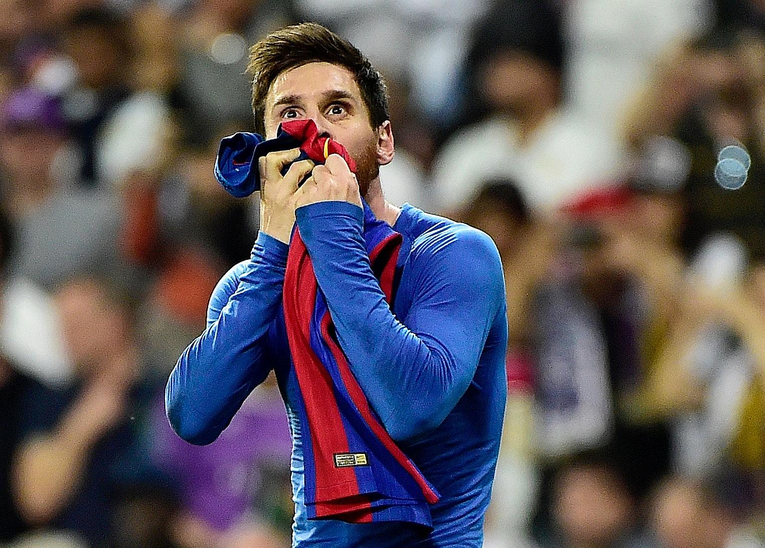 Lionel Messi kissing the Barcelona jersey in celebration back in 2017. The Argentinian confirmed yesterday that he will be staying with the Catalan giants, insisting that he could never take "the club of his life" to court. PHOTO: EPA-EFE