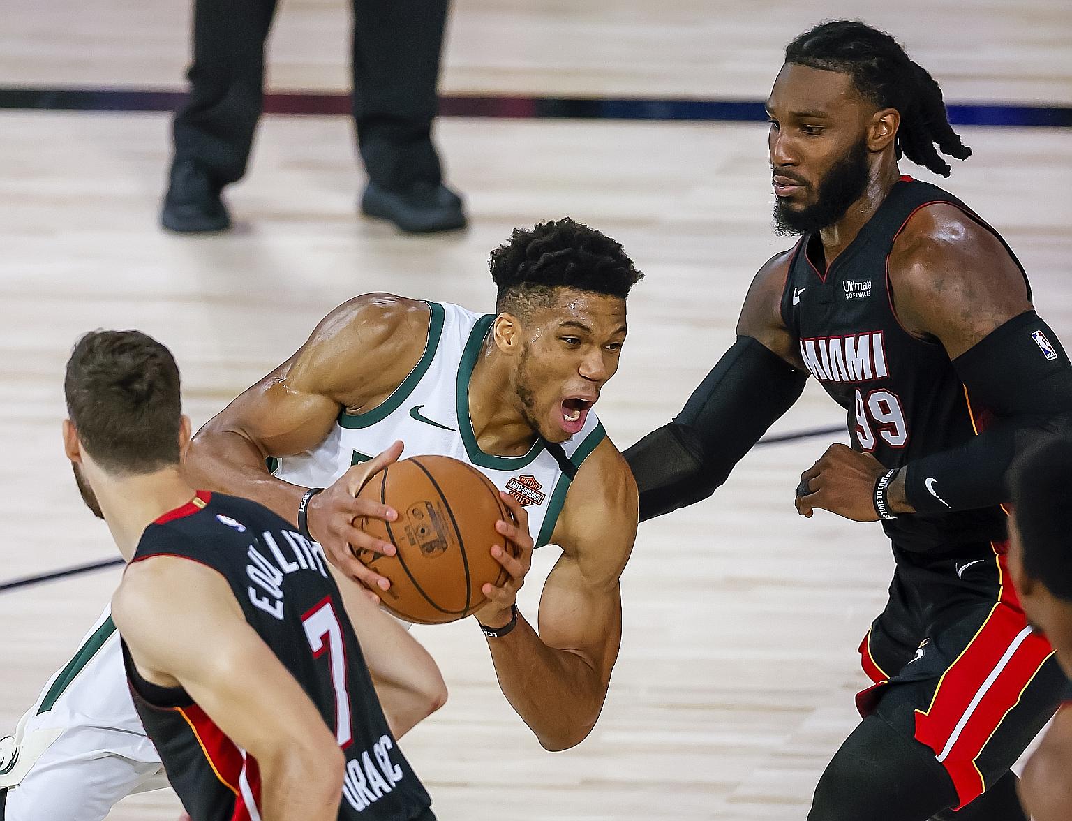 Bucks' Greek forward Giannis Antetokounmpo trying to get past Heat's Slovenian guard Goran Dragic and forward Jae Crowder in their 115-100 loss on Friday. No NBA team has won a series from 3-0 down in 139 previous contests.