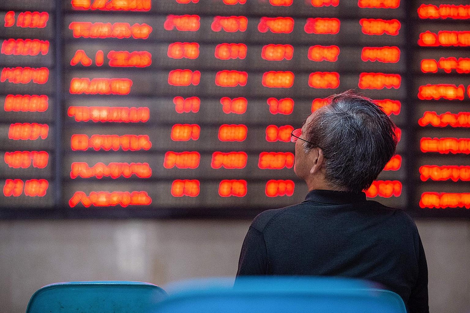 An investor in China looking at a screen showing stock market movements in July. With the economy reeling from the pandemic, policymakers in China have pumped out liquidity and eased curbs on shadow banking to backstop small businesses and struggling