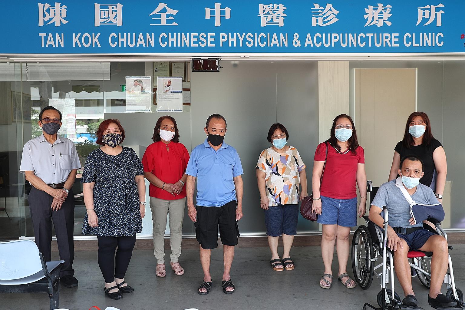 Madam Jenny Chow (centre), who was given up for adoption when she was three months old, comparing birth certificates with her sister, Madam Lua Siew Eng, in Bedok yesterday. Madam Lua also brought photos (below) to the reunion. With them were with Ma