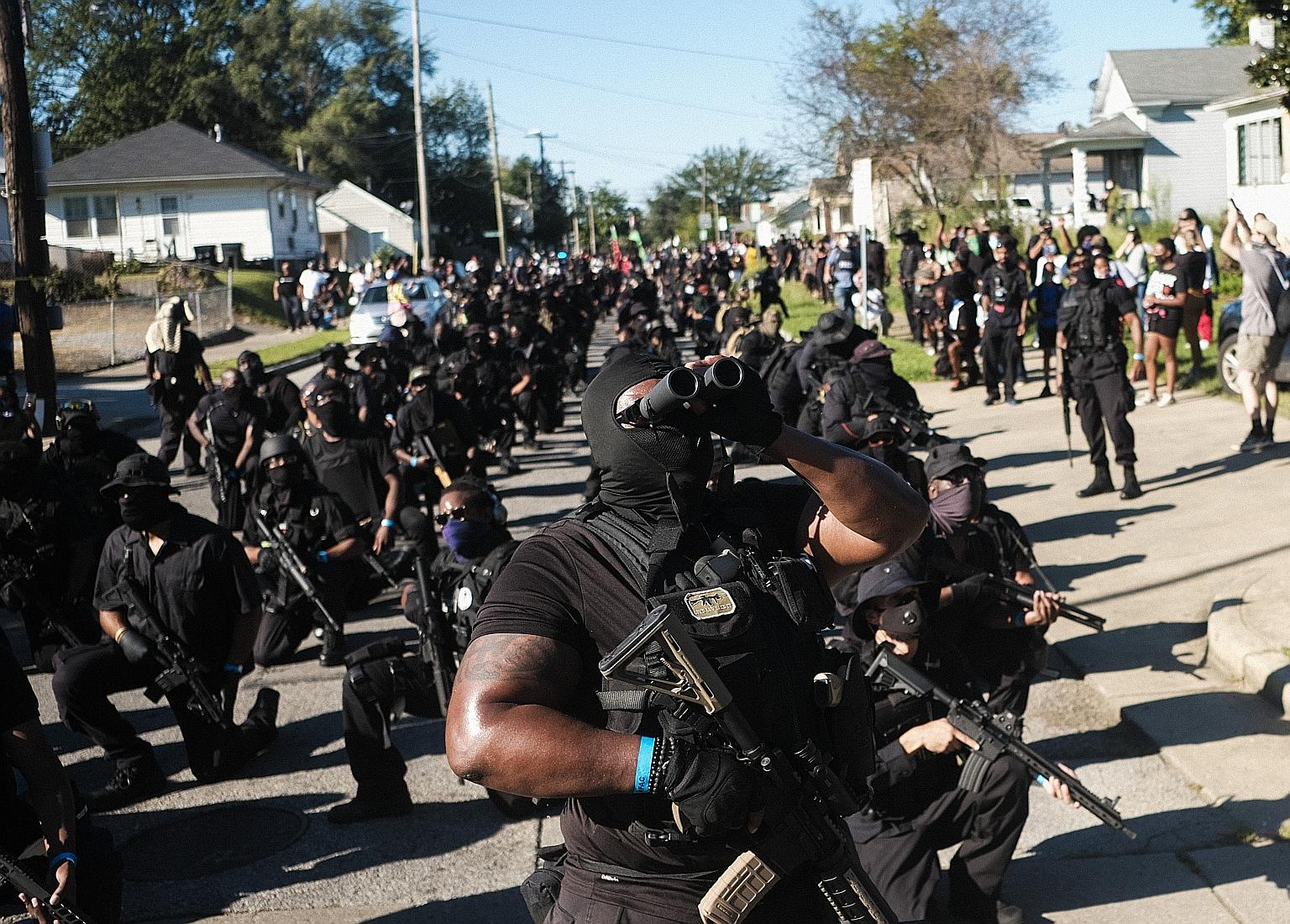 Demonstrators armed with assault rifles keeping watch during a protest outside Churchill Downs in Louisville, Kentucky, last Saturday. PHOTO: BLOOMBERG