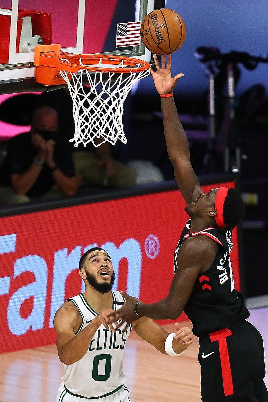 Toronto's Pascal Siakam, finishing with 23 points, making a basket over Boston forward Jayson Tatum during Game 4 of their Eastern Conference semi-final series. The Raptors won 100-93 to level the best-of-seven series. PHOTO: REUTERS