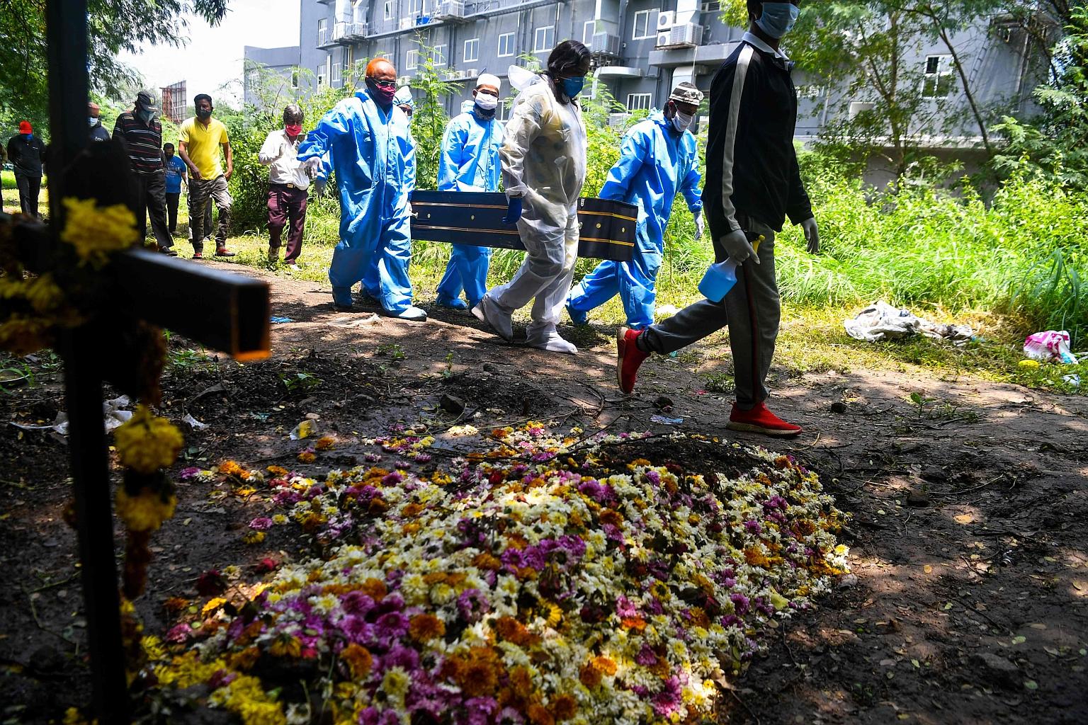 Volunteers carrying the coffin of a Covid-19 victim in the city of Pune, Maharashtra, yesterday. The death toll has hit 71,642 in India.