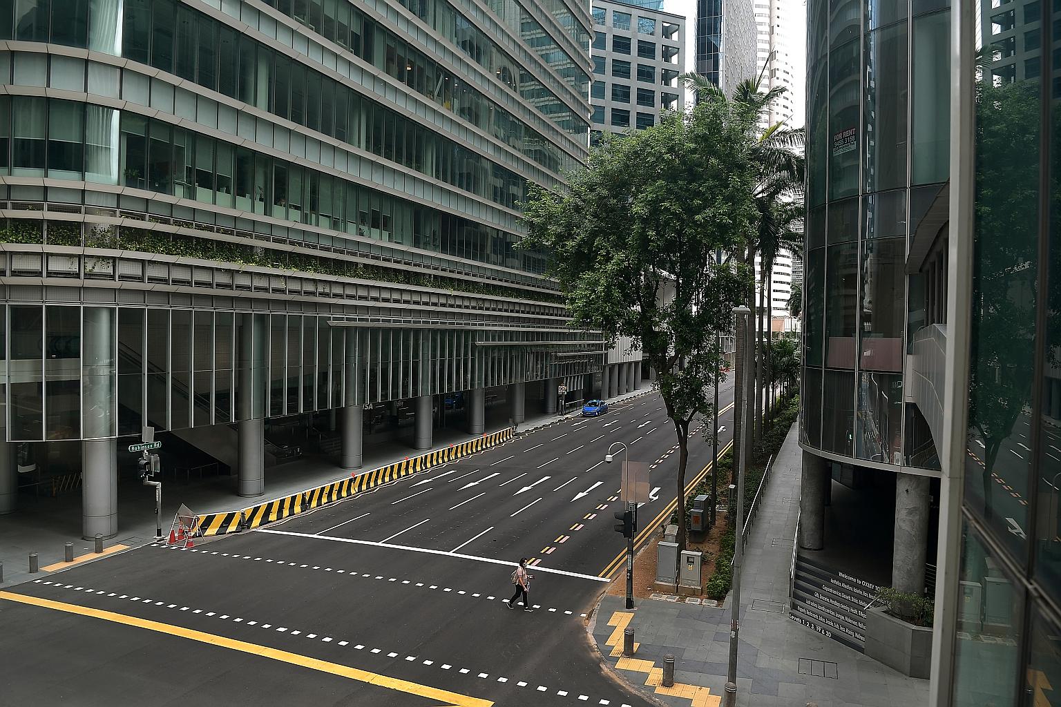 An almost deserted Robinson Road during Singapore's circuit breaker period in April. A DBS report notes that the second-quarter results season had reflected the impact of global Covid-19 lockdowns, with a sharp 14.9 per cent cut in forecast earnings
