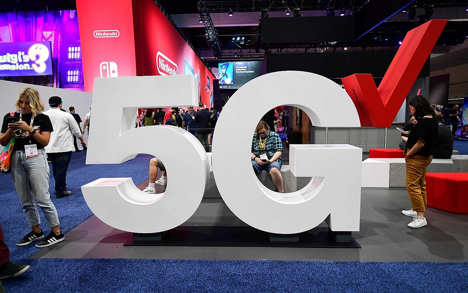 A Verizon 5G display at last year's Electronic Entertainment Expo in Los Angeles. The next-generation 5G wireless network is expected eventually to connect and enable high-speed video transmissions and self-driving cars, among other uses. PHOTO: AGEN