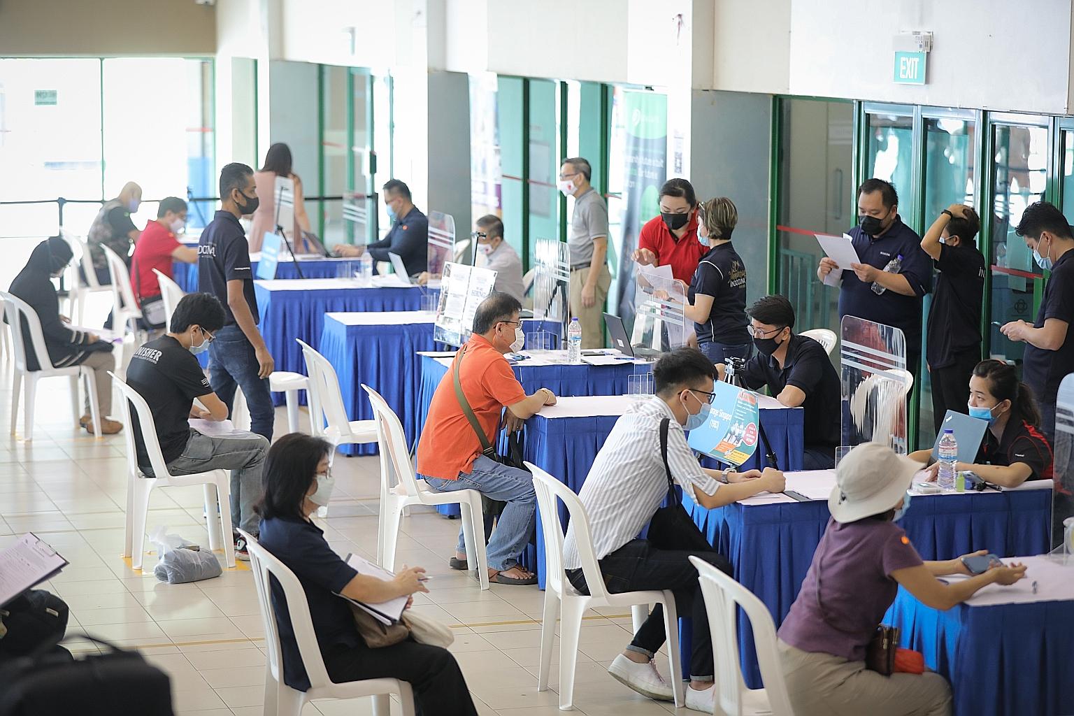 People at a job fair held by the National Trades Union Congress' Employment and Employability Institute at Chong Pang Community Club last month. Retrenchments more than doubled in the second quarter of this year, with 6,700 workers laid off, up from