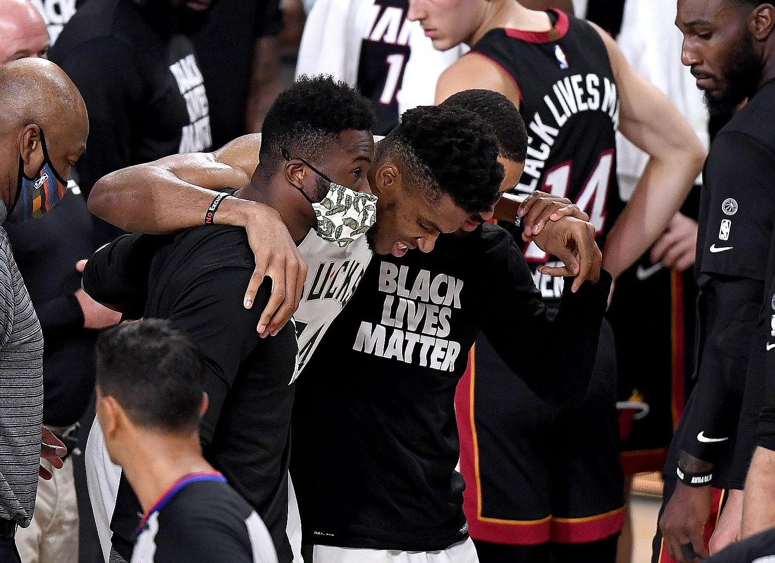 Giannis Antetokounmpo is helped off court by Bucks teammates but the East top seeds beat Miami to cut the deficit to 3-1.