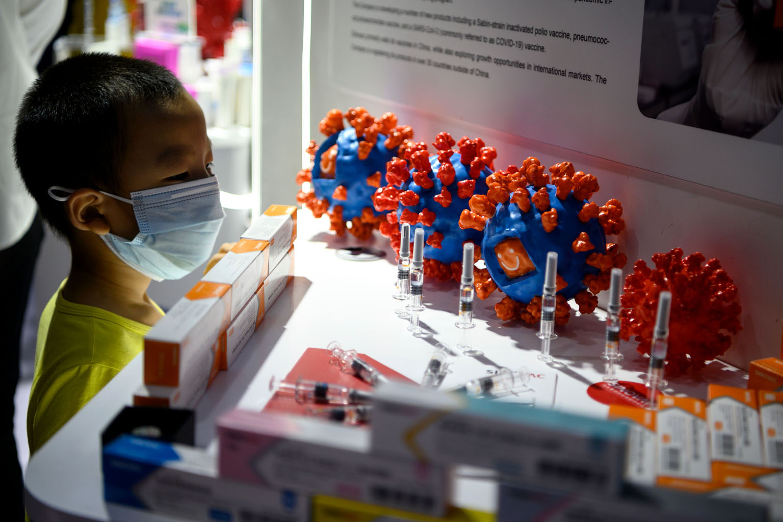 A boy looking at Sinovac's Covid-19 vaccine candidate on display at the China International Fair for Trade in Services in Beijing on Sunday. PHOTO: AGENCE FRANCE-PRESSE