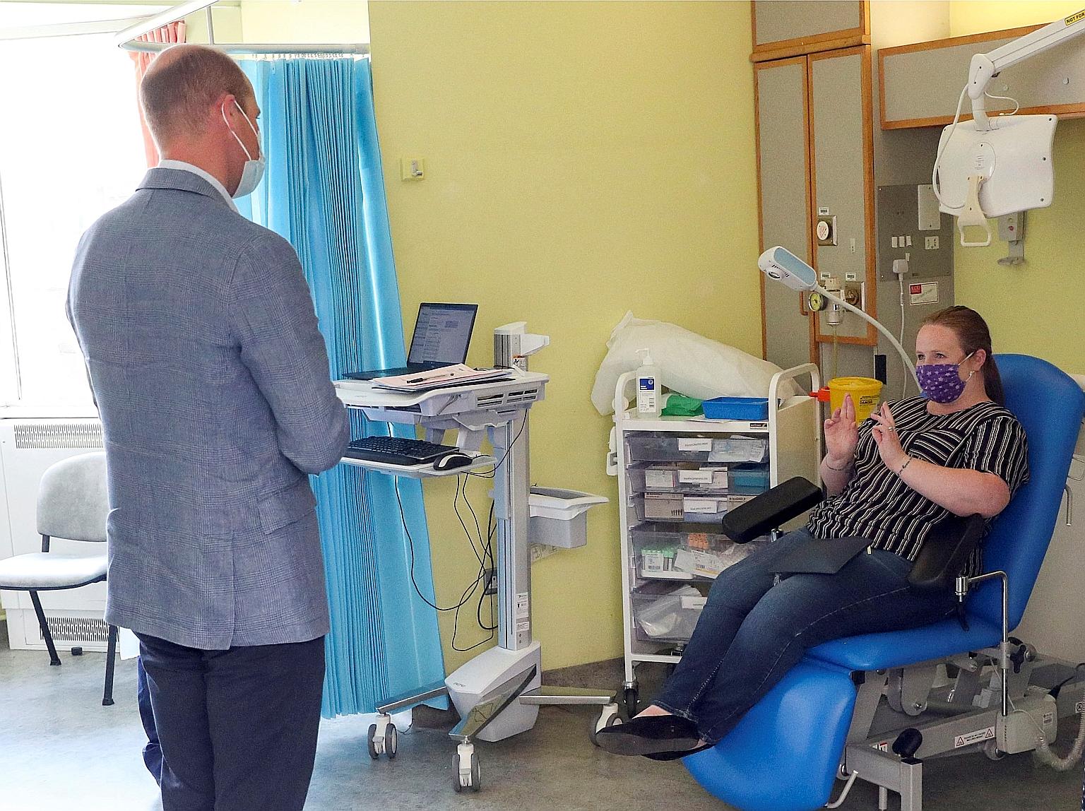 Britain's Prince William talking to a patient participating in a Covid-19 vaccine trial during a visit to the Oxford Vaccine Group's facility at Churchill Hospital in Oxford in June. British drugmaker AstraZeneca's vaccine, which the company is devel