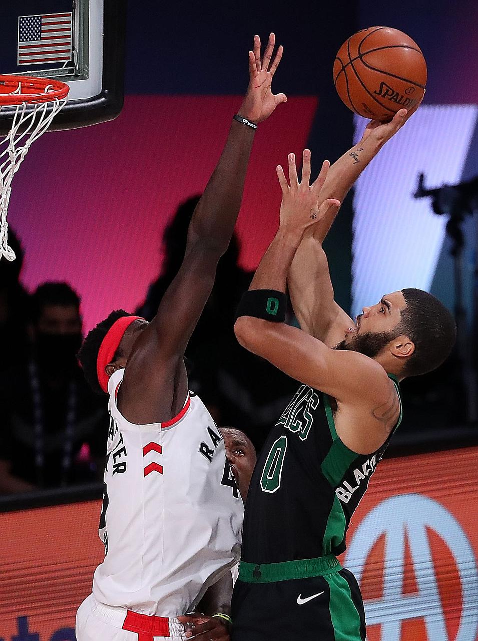 Boston's Jayson Tatum going for a shot as Toronto's Pascal Siakam defends in Game Seven of their Eastern Conference semi-finals in Lake Buena Vista, Florida. Boston eliminated the champions and are aiming to reach the NBA Finals for the first time in