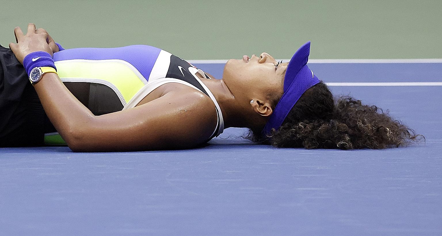 Enjoying a quiet moment after coming from behind to beat Victoria Azarenka for the US Open title on Saturday, Naomi Osaka can be proud that she has successfully channelled her sporting prowess to be a voice for social justice. PHOTO: EPA-EFE