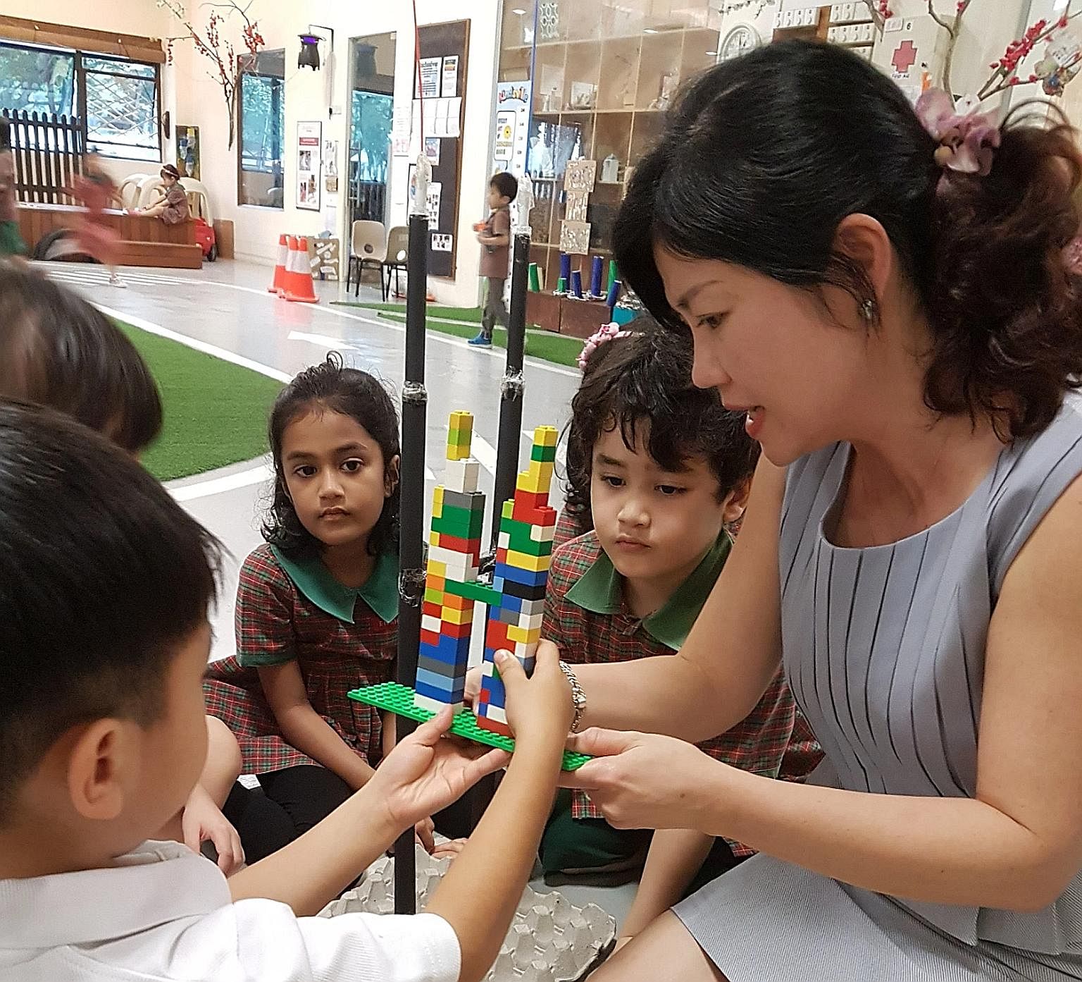 EtonHouse Pre-School Mountbatten 223 senior principal Josephyne Ho, 50, interacting with pupils. She joined the international school group in 2003 after a decade with SIA Group.