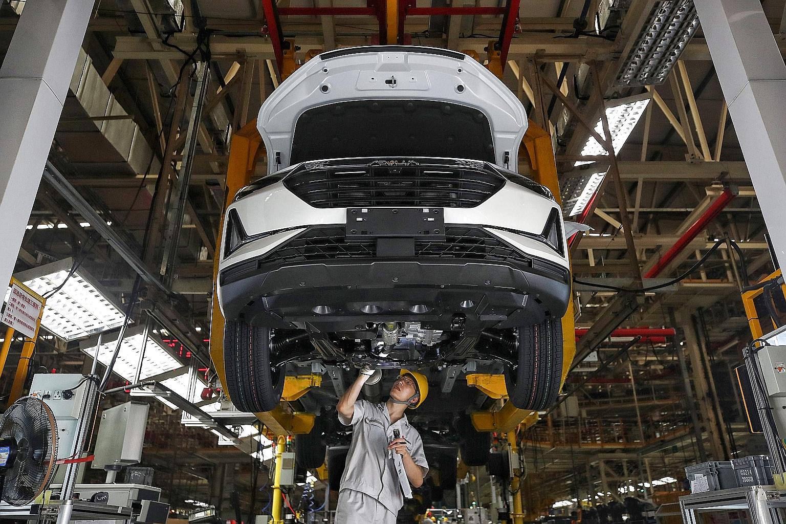 A worker on an assembly line at a Dongfeng Motor factory in Wuhan in China's central Hubei province on Monday. Consumer confidence in China has been picking up, with auto sales rising 11.8 per cent last month from a year earlier. PHOTO: AGENCE FRANCE