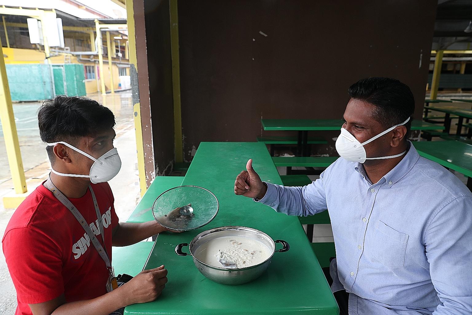 Mr Mamoun Abdulla Al (left), a worker from Bangladesh, with Mr Sheik Ismail Mohamed Ashad, a senior investigation officer with the Singapore Police Force, at the S11 Dormitory. They had got together to enjoy a pudding dish called payesh that Mr Mamou