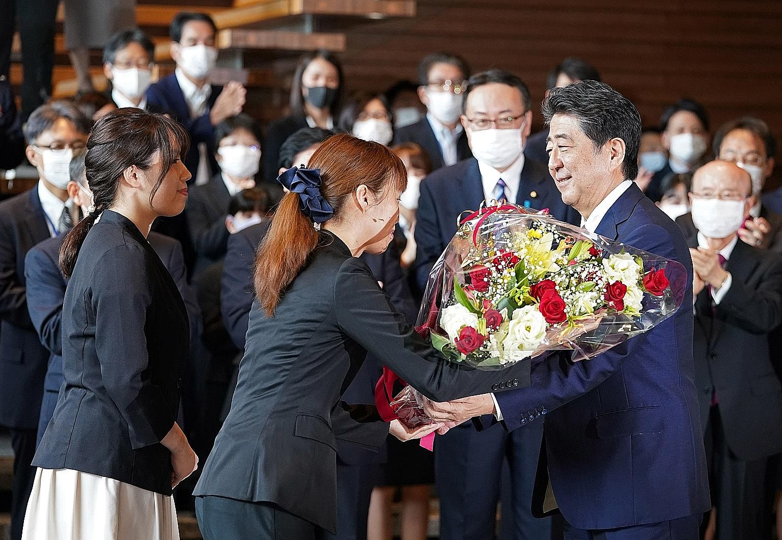 Mr Shinzo Abe, Japan's longest-serving leader with 3,188 days at the helm, called time on his tenure yesterday, receiving a bouquet and a poignant send-off upon his departure from the prime minister's official residence in Tokyo. Mr Yoshihide Suga (c