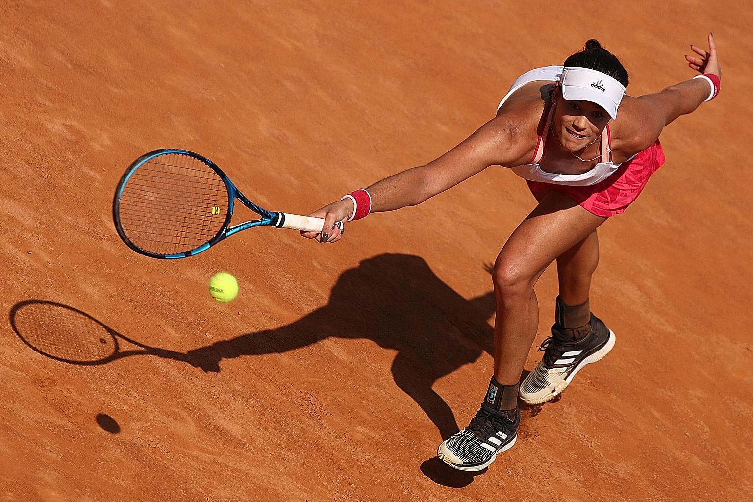 Spaniard Garbine Muguruza hitting a forehand against Coco Gauff at the Italian Open yesterday. She won the 2hr 27min battle.