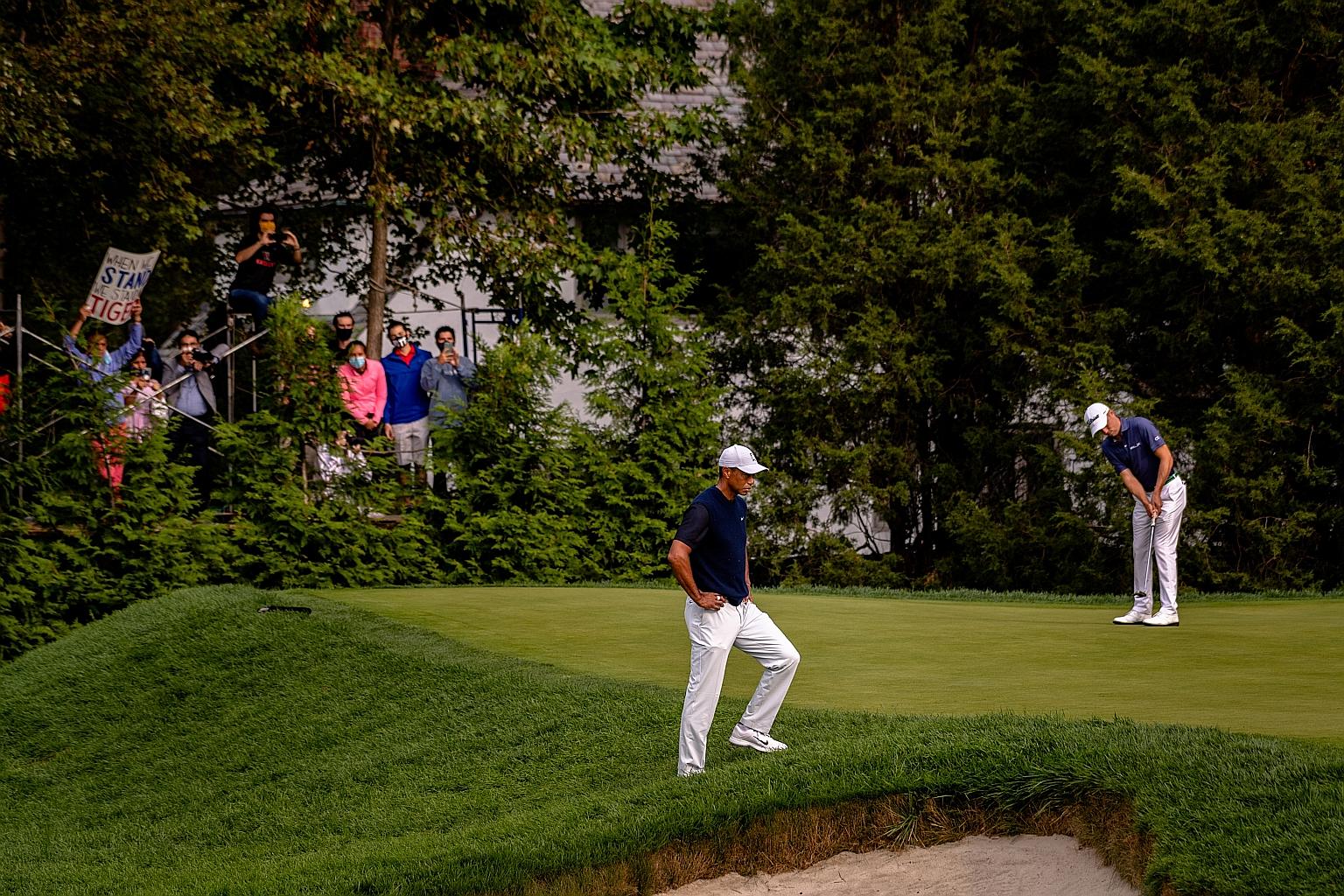 Fans on a makeshift stand outside the Winged Foot Golf Club watching Americans Tiger Woods and Justin Thomas (right) during the opening round of the US Open in Mamaroneck, New York on Thursday. While Thomas enjoyed one of his better rounds tee to gre
