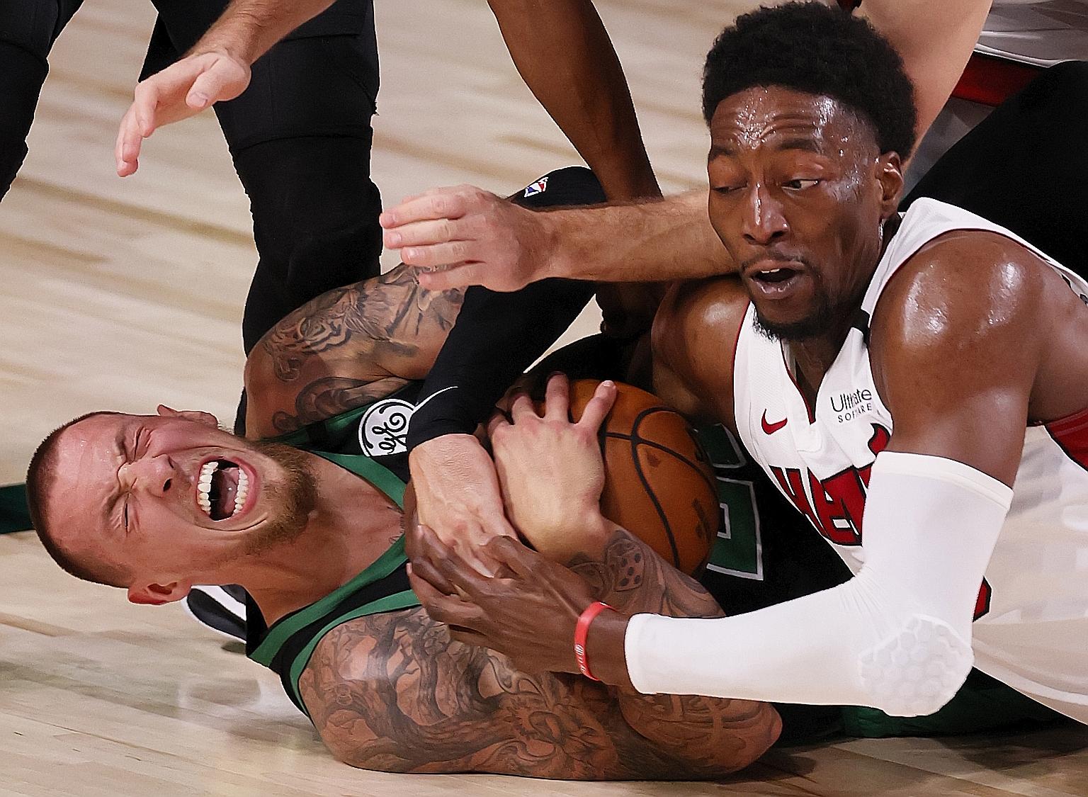 Boston centre Daniel Theis (left) holding on to the ball as Miami forward Bam Adebayo tries to strip it away in Game 2 of the Eastern Conference Finals.