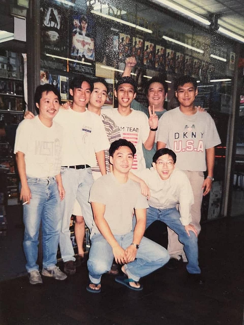 (Above) Madam Laurel Khoo, owner of Rida Video Centre, at the shop on Sept 7. (Right) Madam Khoo's late husband Ooi Kai Peng (standing, second from far right) with staff of Rida Video Centre in Serene Centre, where the video-rental shop was located f