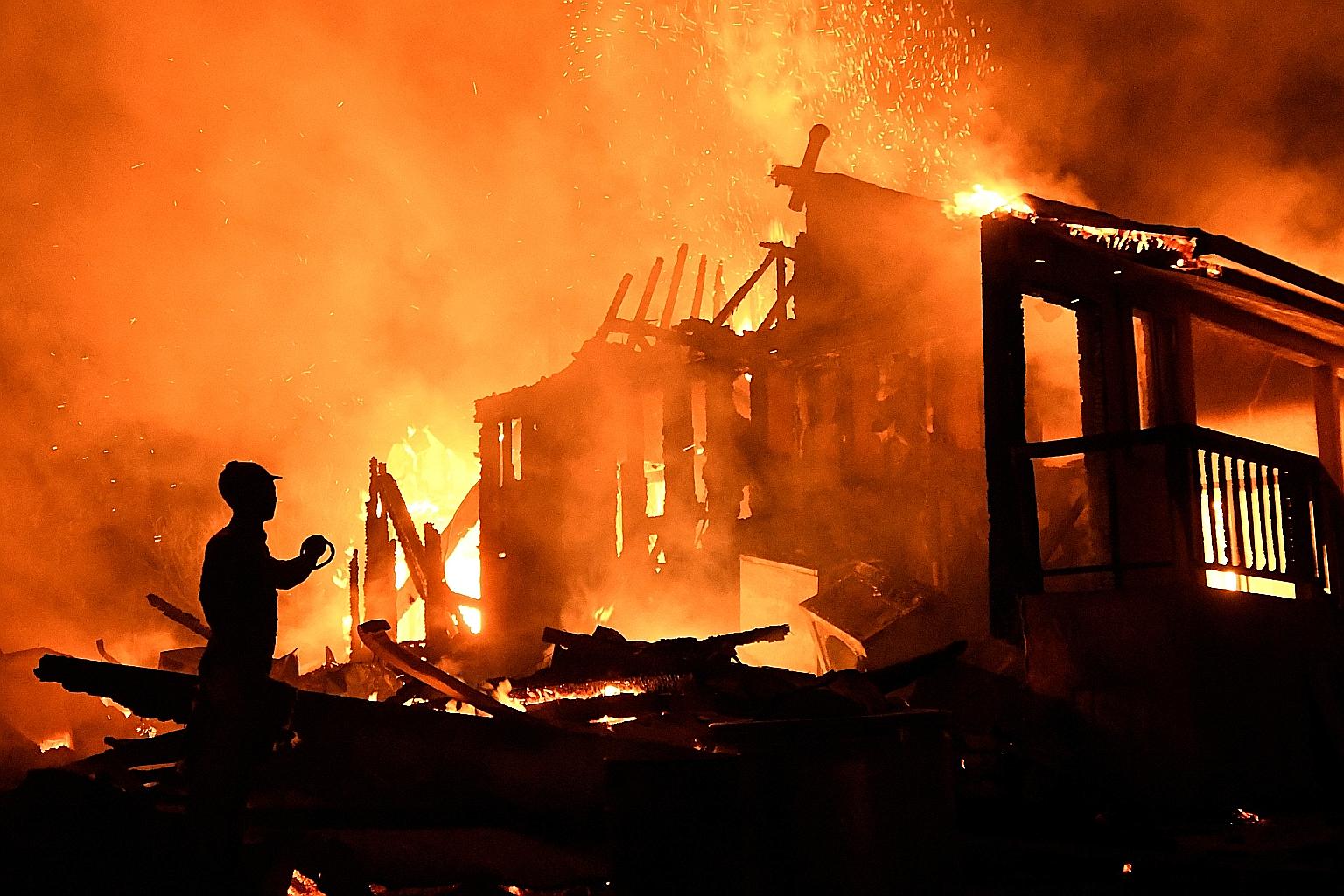 One of many homes engulfed by the Bobcat Fire in Juniper Hills, California, last Friday. A shift to cooler, damp weather on Saturday helped over 9,000 personnel fight 29 wildfires across Washington and Oregon states, including the Riverside Fire sout