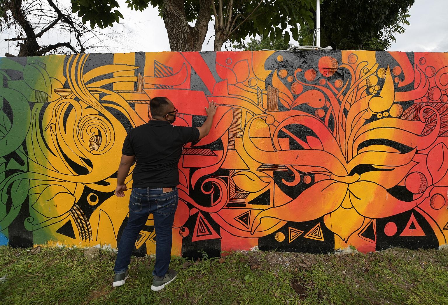 A resident of Jamiyah Halfway House with the mural he helped to design. Mural painting, which is an extension of the halfway house's art therapy programme, is among the new initiatives the centre is using to help former drug addicts stay on the right