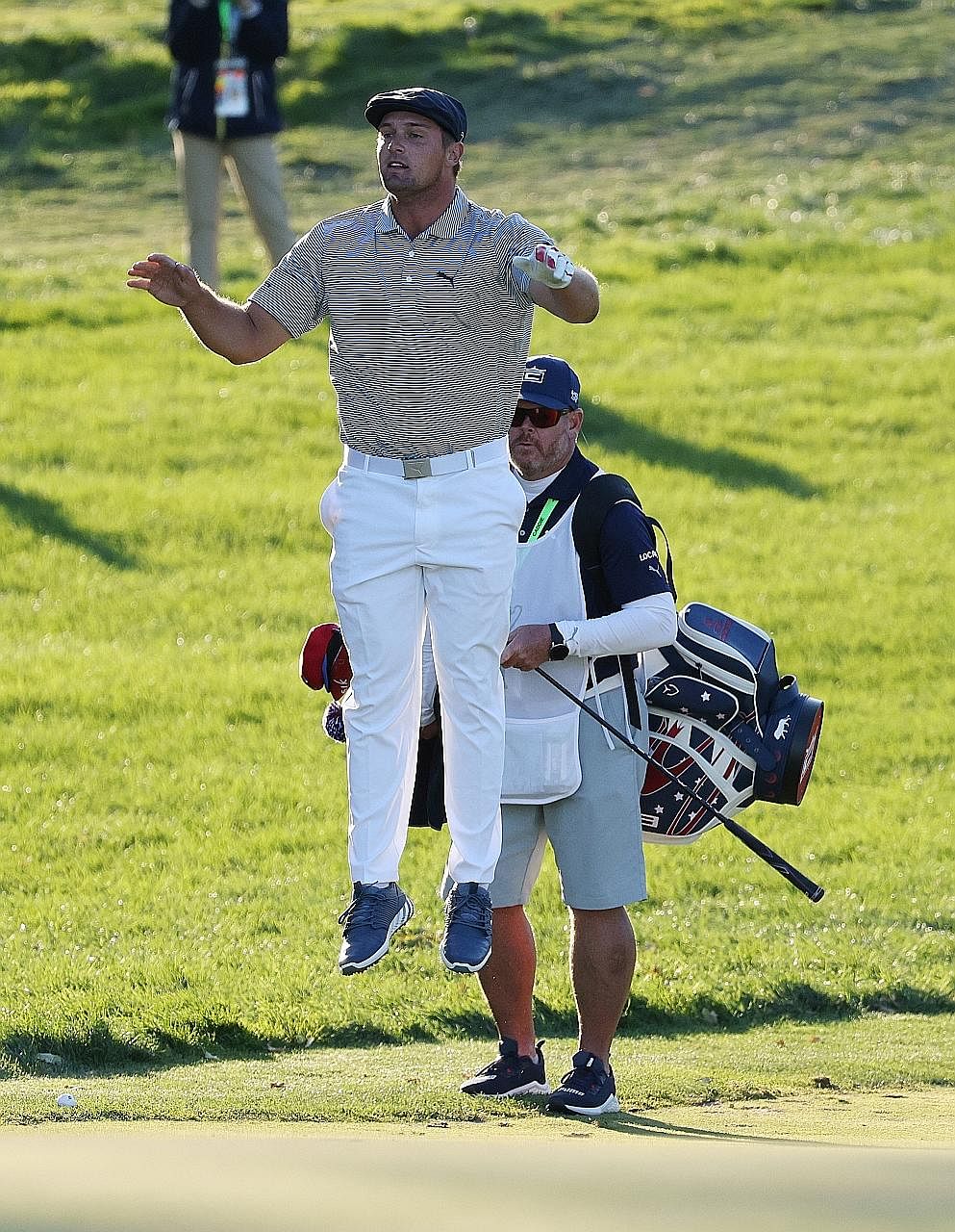 Bryson DeChambeau jumping to check the 18th green before playing a chip at Winged Foot Golf Club. He parred the par-four hole despite missing the fairway. He hit 23 fairways all week - an all-time low for a US Open champion, beating Angel Cabrera's 2