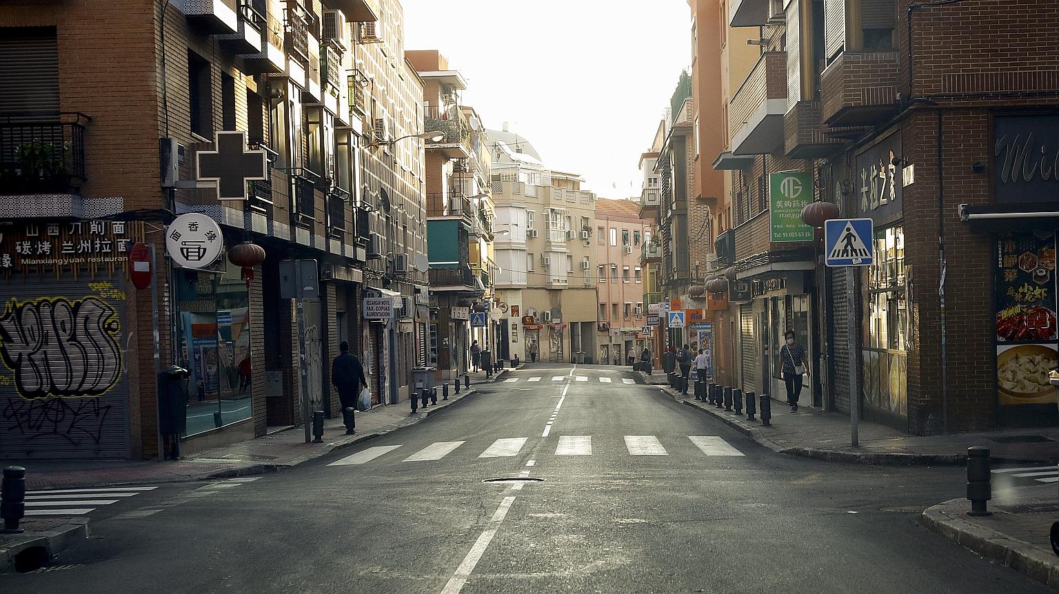 A quiet street yesterday in Madrid's Usera district, one of the areas under partial lockdown. Spain's recent spike in infections, peaking at over 10,000 a day, took its total to above 670,000, the highest in Western Europe.