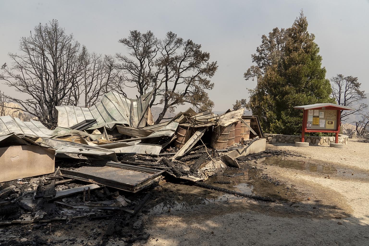 The burnt remains of the visitor centre in the Devil's Punchbowl Natural Area in Pearblossom, California, on Sunday. There are many factors behind the state's record fires, including years of drought worsened by climate change that have left endless 