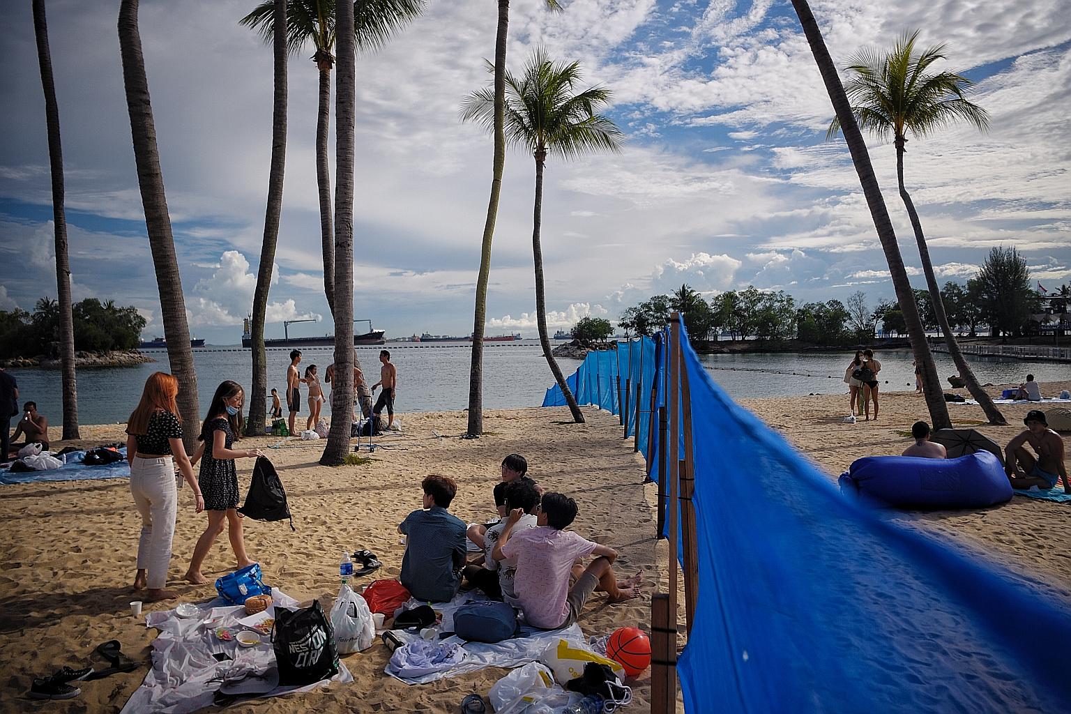 Visitors at Siloso Beach yesterday. The booking system will be trialled for an initial period of three months for Tanjong, Palawan and Siloso beaches. Since July, the three beaches have been segmented into a total of seven zones, each with a capacity