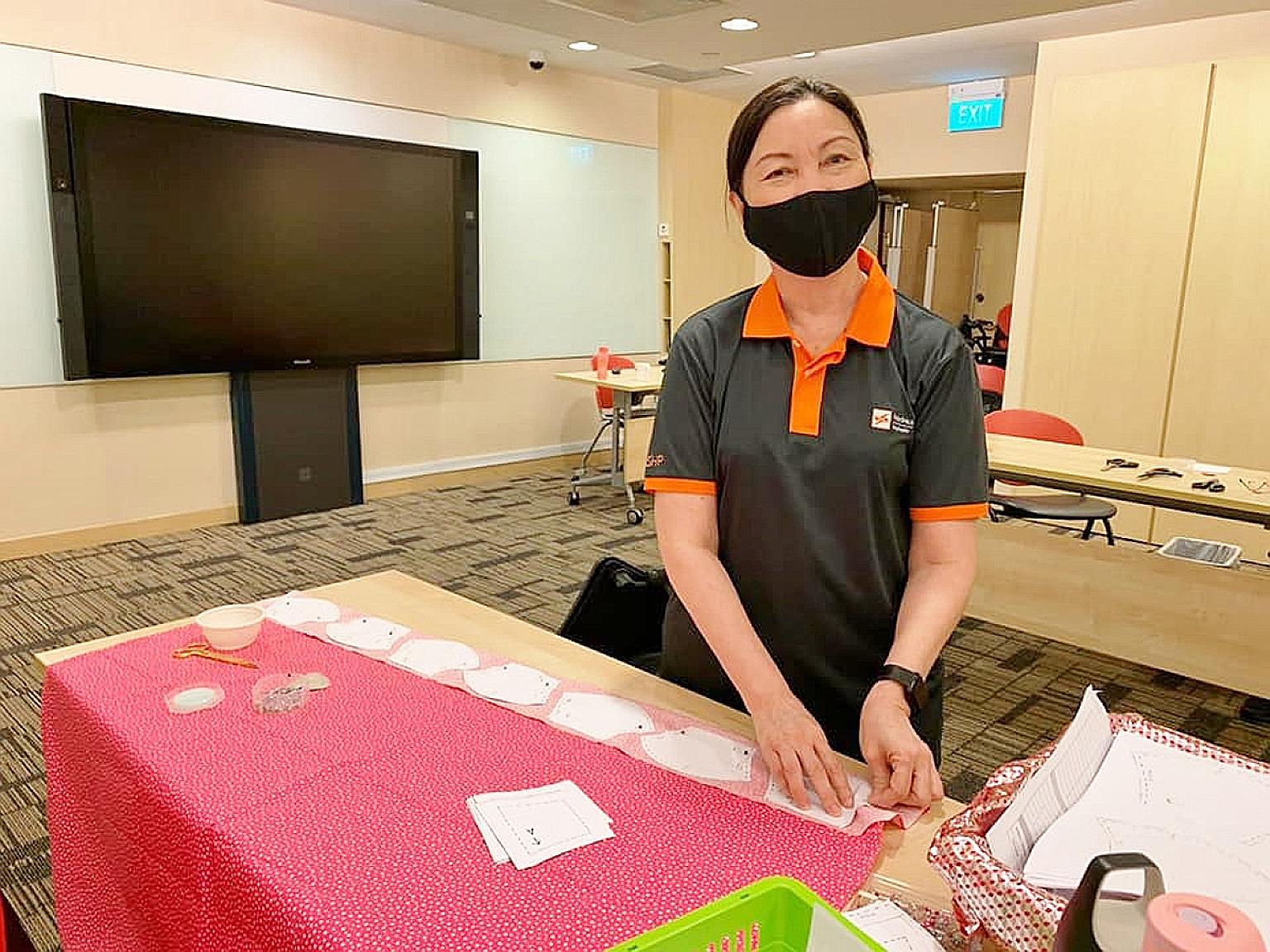 Nurse clinician Ou Lee Hua (above) and senior nurse manager in nursing administration Daisy Tng (left) from SingHealth Polyclinics working on the masks. They were among SHP nurses who assembled and sewed masks to raise money for needy patients.